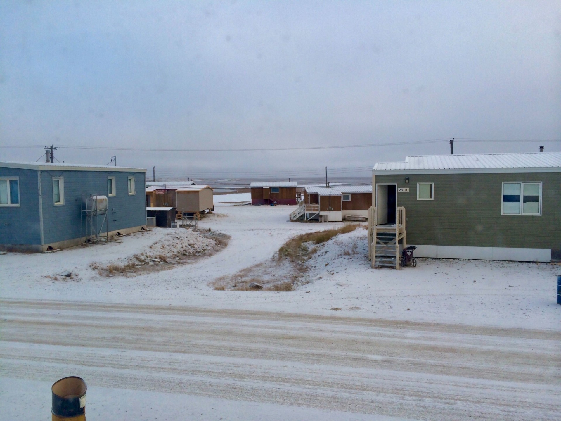 Single story houses in a snowy landscape in Nunavut, Canada
