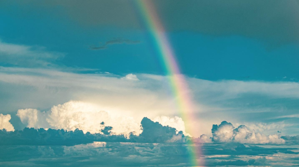 Rainbow in the sky over clouds.